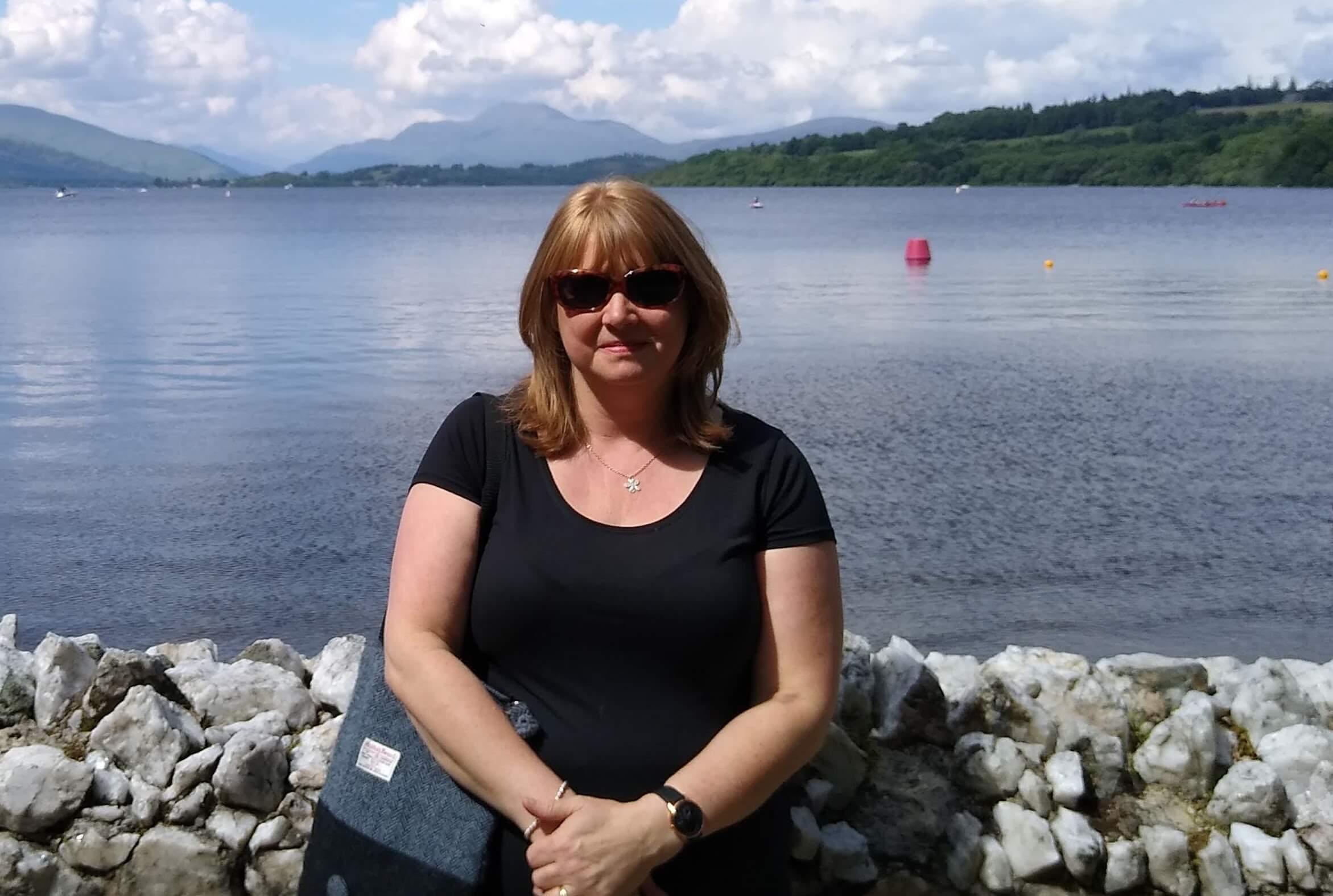 Woman stood by a lake