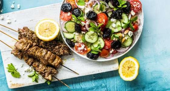 Spring lamb skewers and california prune salad in a bowl