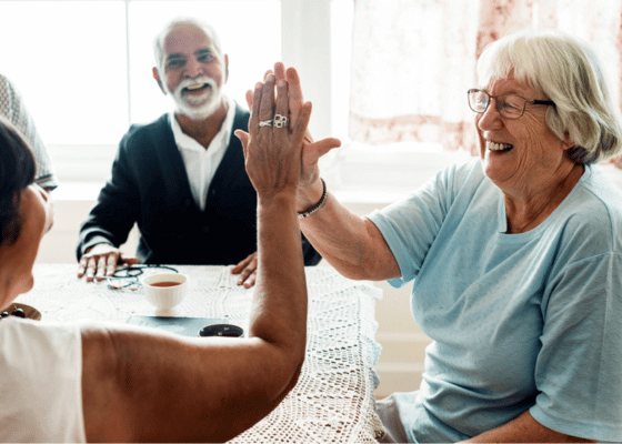 Older people giving a high five 