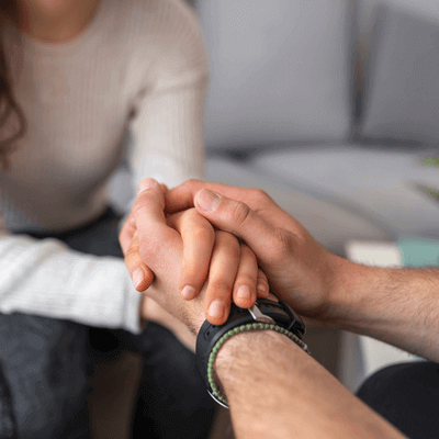 Two people holding hands