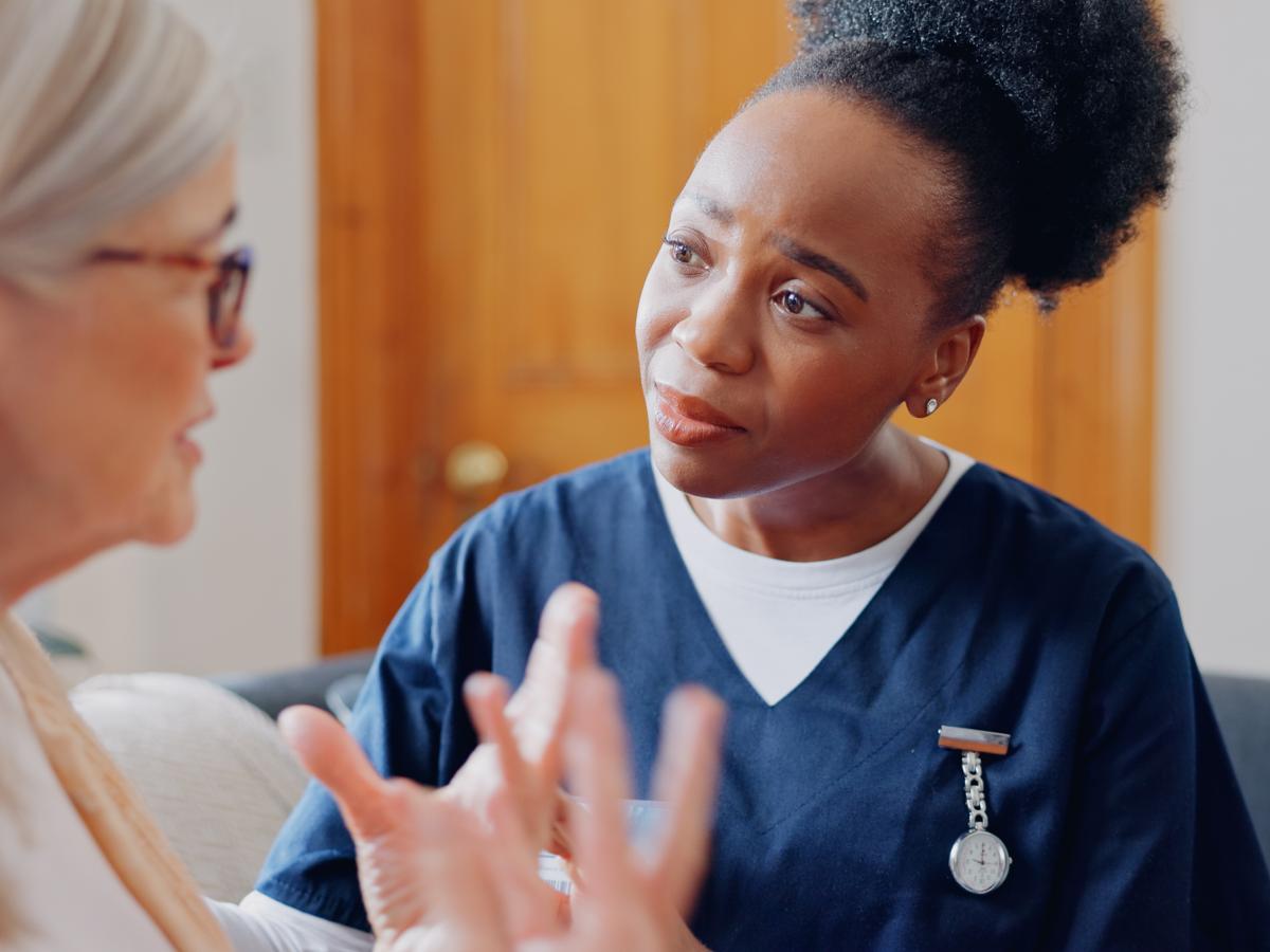 A healthcare professional listens carefully to a patient