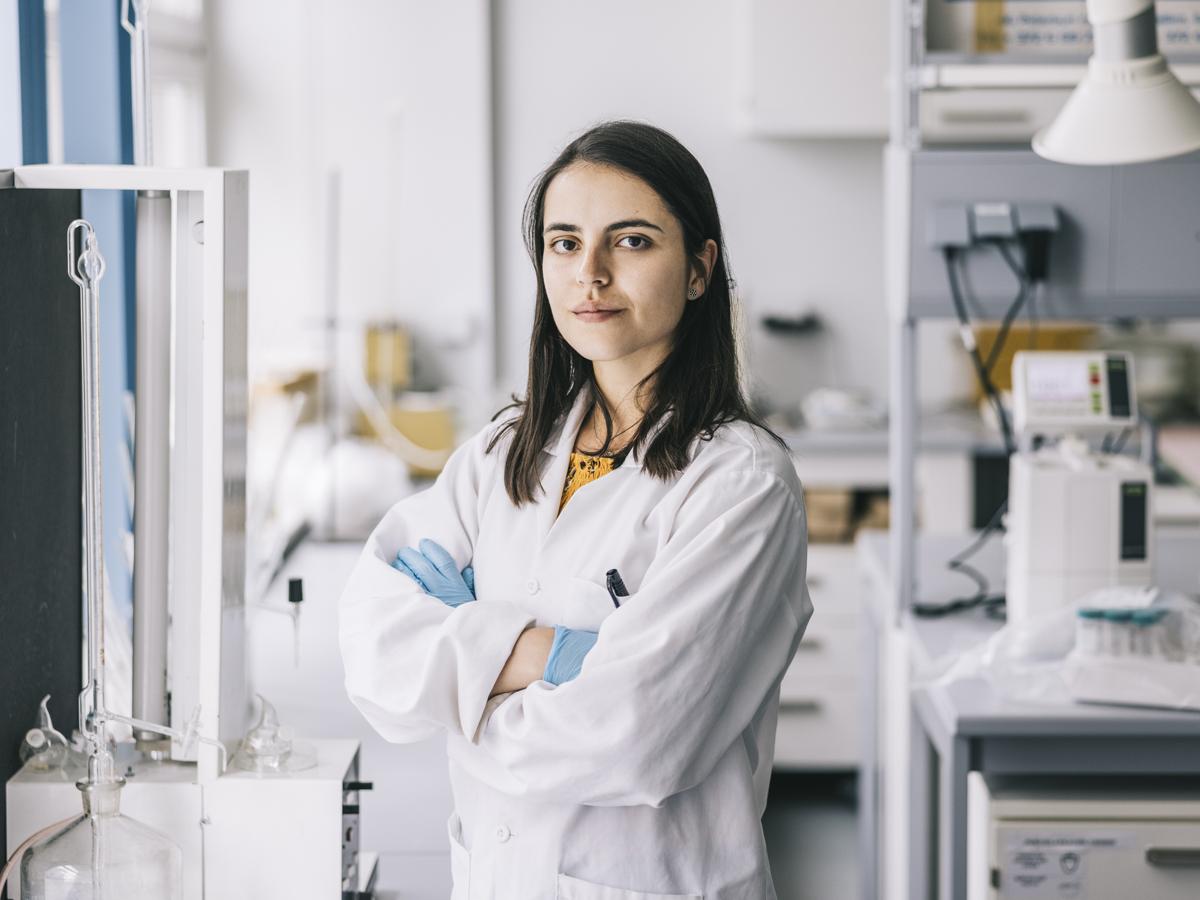 Researcher with her arms crossed in a lab