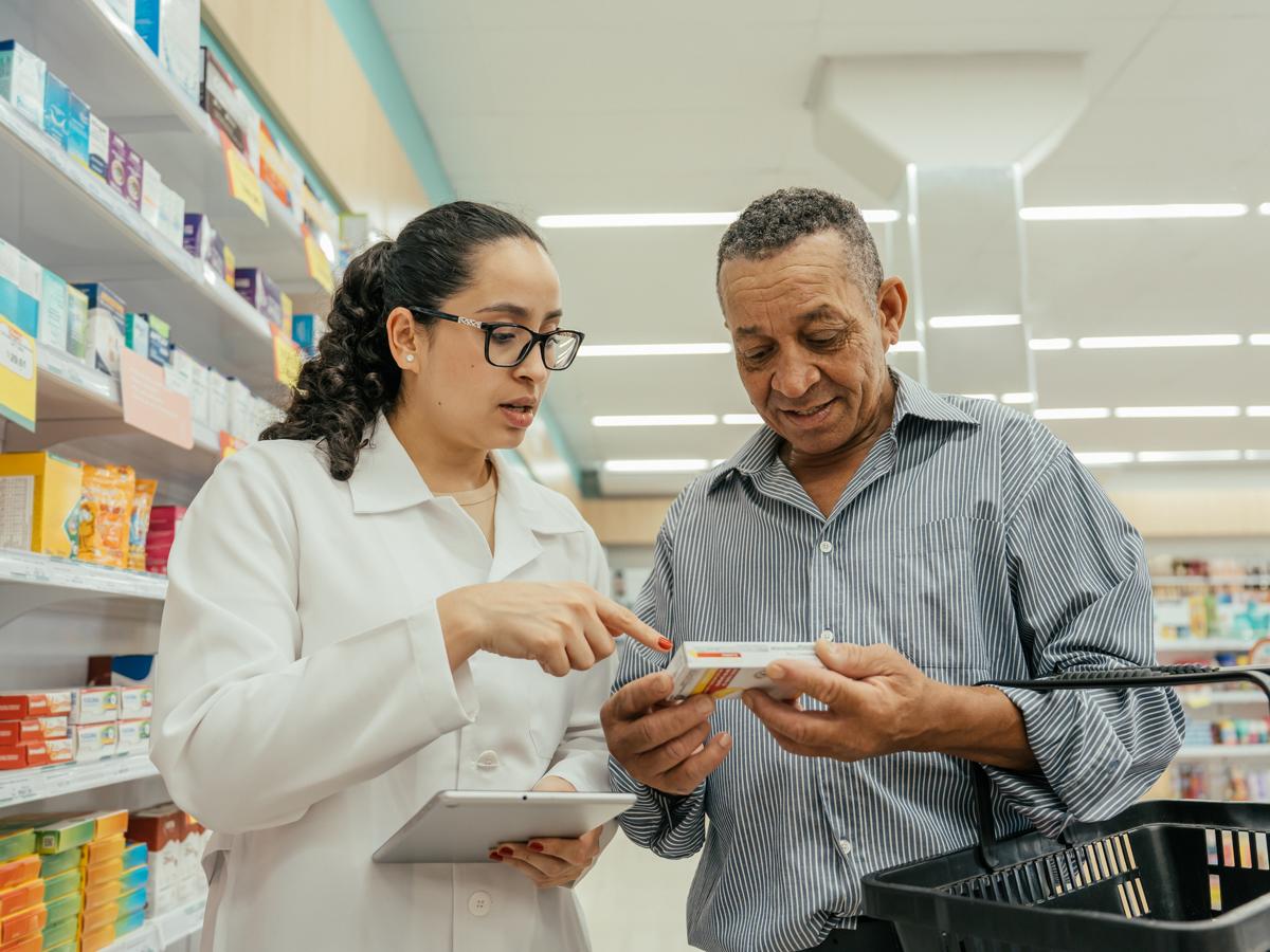 Pharmacist advising a patient on medication