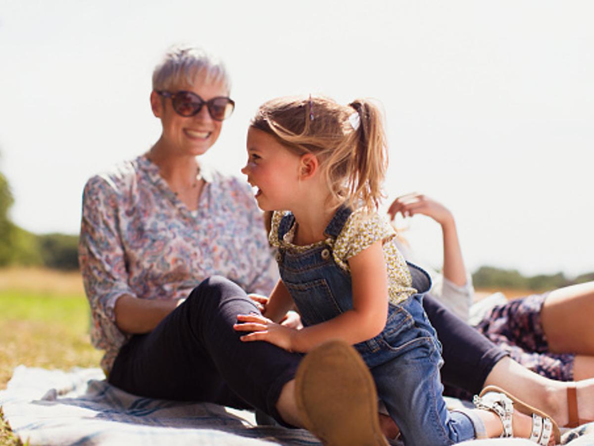 A grandmother and grandchild sitting in the sun